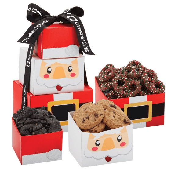 Santa Tower gift boxes with chocolate chip cookies, chocolate pretzels, and candy coal, tied with a custom logo ribbon