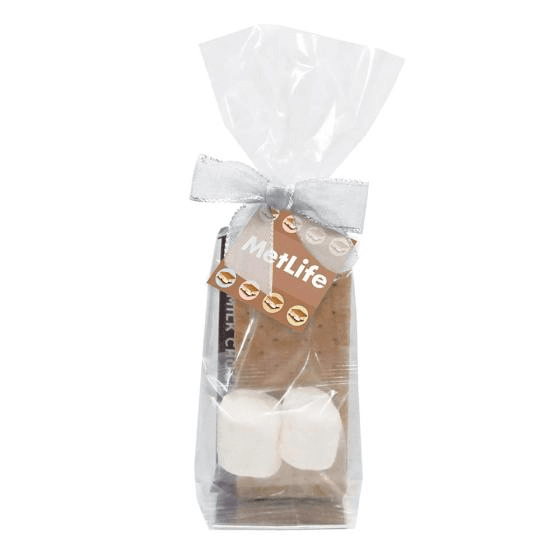 S'mores kit with graham crackers, chocolate, and marshmallows in a clear bag with a bow and custom logo tag